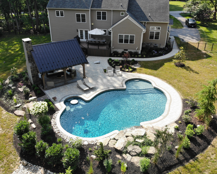 Overview of pool and pavilion in a home's backyard -Burkholder Landscape