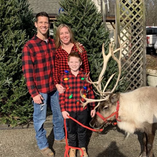 Mark Burkholder Smiling Family with Reindeer | Burkholder Holiday Market