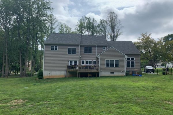 rearview of a home with deck | Before Picture of ew Landscaping Project In Malvern | Burkholder Landscape