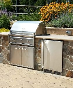Outdoor kitchen with natural stone veneer | Burkholder is one of the local Main Line Landscape Design Companies