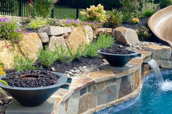 Pool seat walls and steps using Techo-Bloc 6” Mini Creta Architectural caps in beautiful chestnut brown - Pool and Patio Retreat - New Projects by Burkholder Landscape