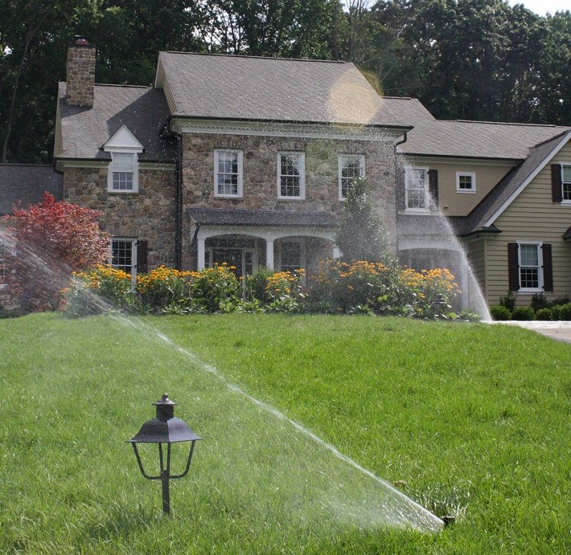 Sprinklers in front yard landscaping - Spring Turf Care Checklist- Burkholder Landscape