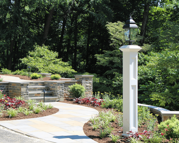 landscaped walkway with column light leading to walkway and backyard -Burkholder Landscape