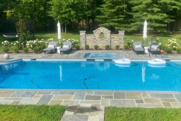 pool with built in spa, flagstone surround and seating | New landscape project | Burkholder Landscape