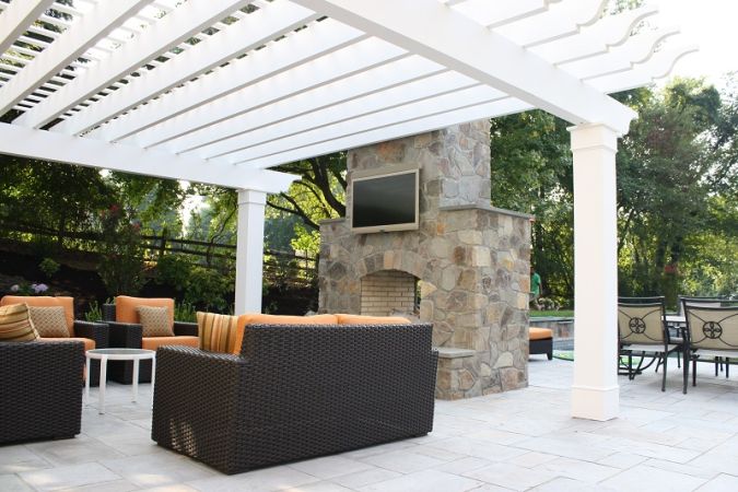 double sided fireplace with entertainment system and pergola - Burkholder