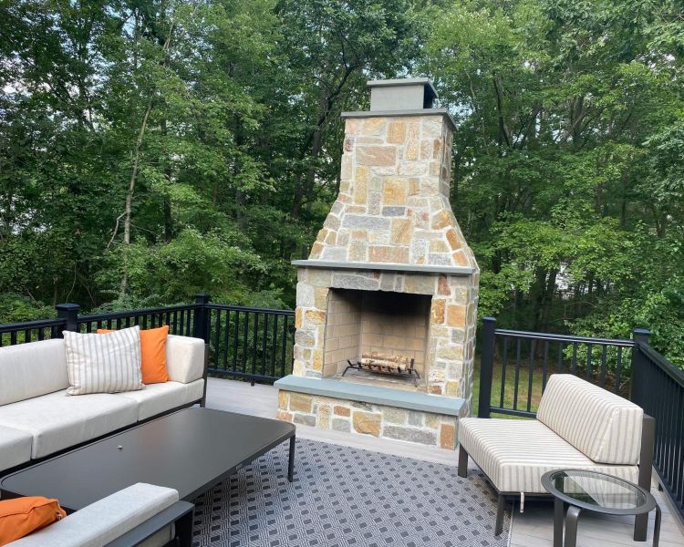 Natural Stone Fireplace on Raised Deck | Burkholder Landscape