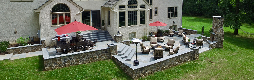 landscaping design in haverford pa patio with chimney and outdoor furniture - burkholder landscape