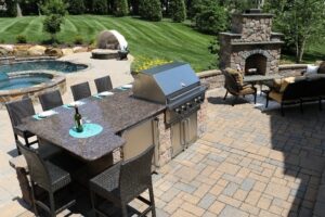 patio kitchen with fireplace pool and hot tub - Burkholder