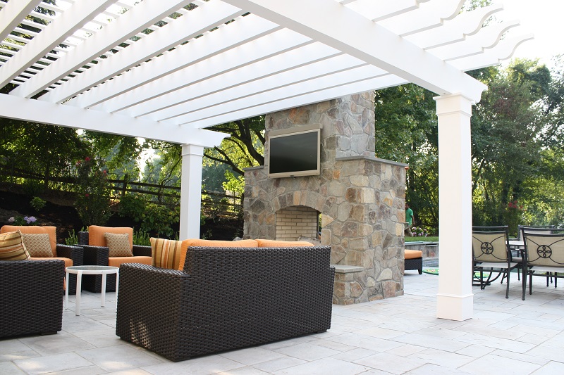 Double sided fireplace with entertainment system and pergola | landscape design features | Burkholder Brothers