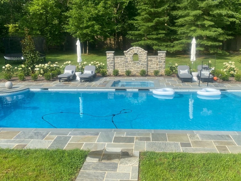 pool with built in spa, flagstone surround and seating | New landscape project | Burkholder Landscape