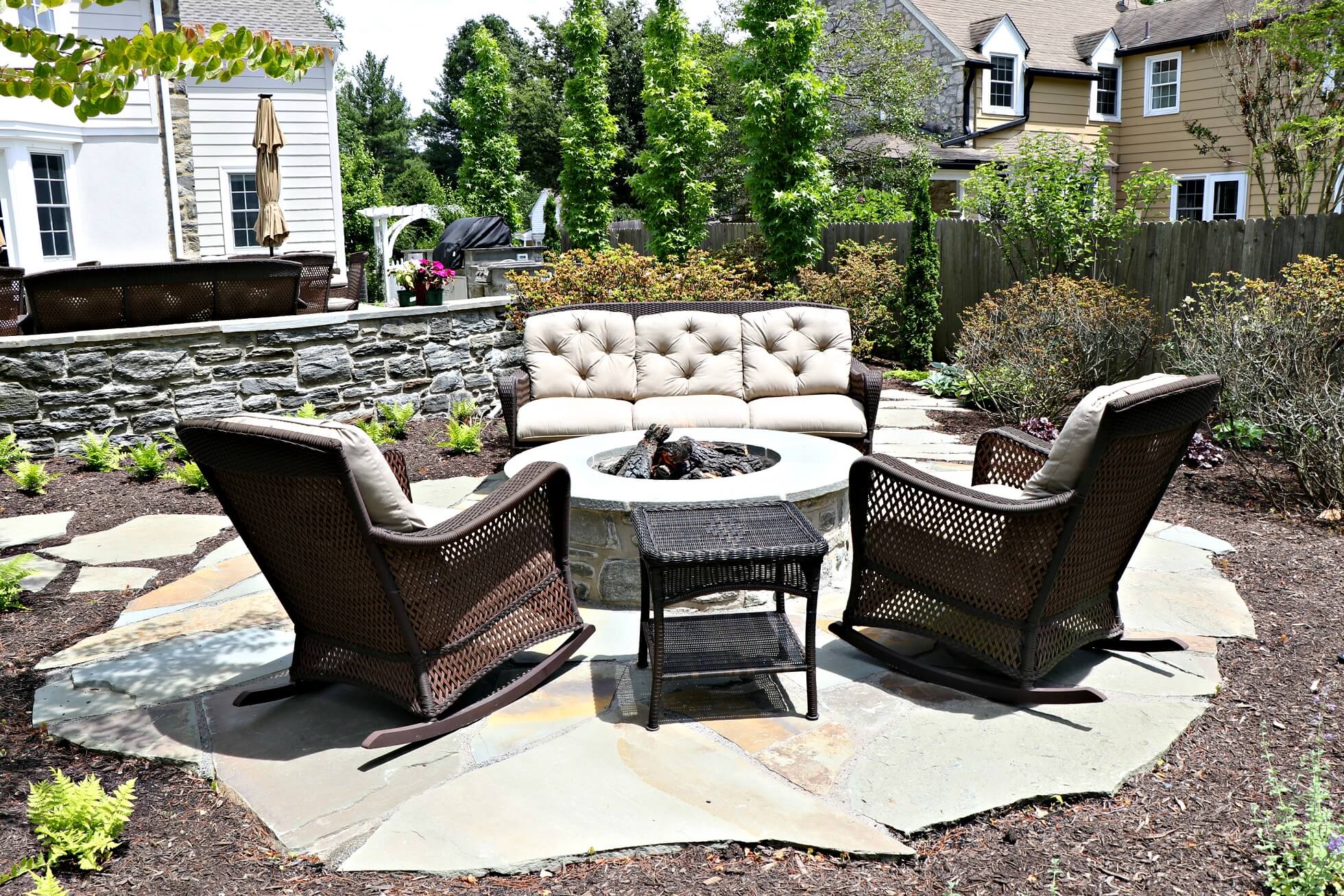 Round firepit with cushioned chairs and couch | Fireplaces and Firepits Options | Burkholder Brothers 