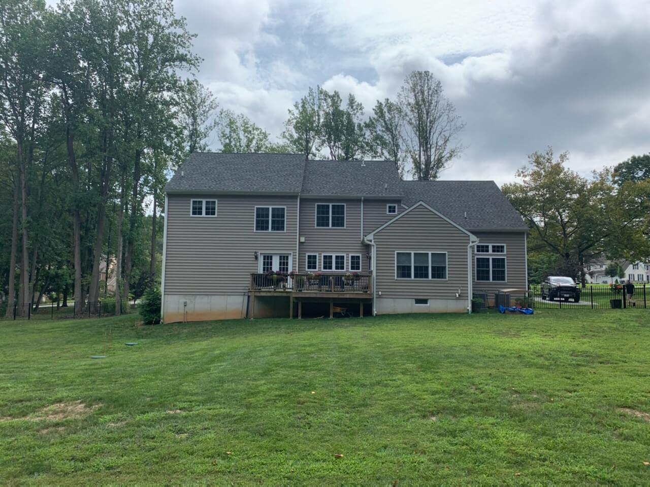 rearview of a home with deck | Before Picture of ew Landscaping Project In Malvern | Burkholder Landscape