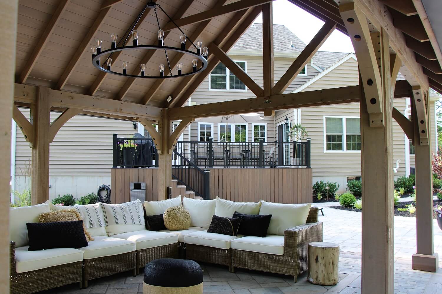 Outdoor pavilion with chandelier and sofa | After Picture of ew Landscaping Project In Malvern | Burkholder Landscape