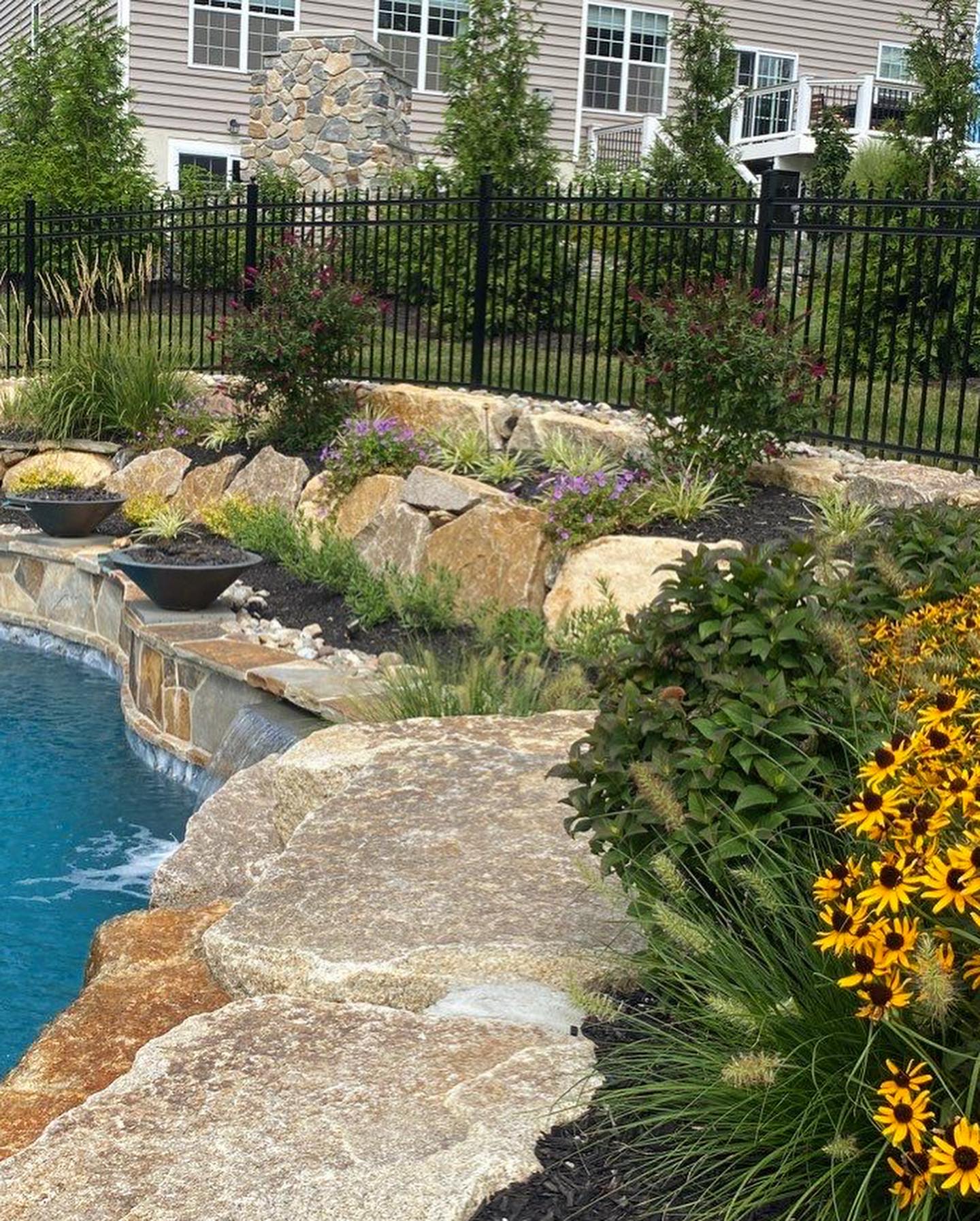Retaining wall using Techo-Bloc 6” Mini Creta Architectural caps in beautiful chestnut brown, and stone granite boulders - Pool and Patio Retreat - New Projects by Burkholder Landscape