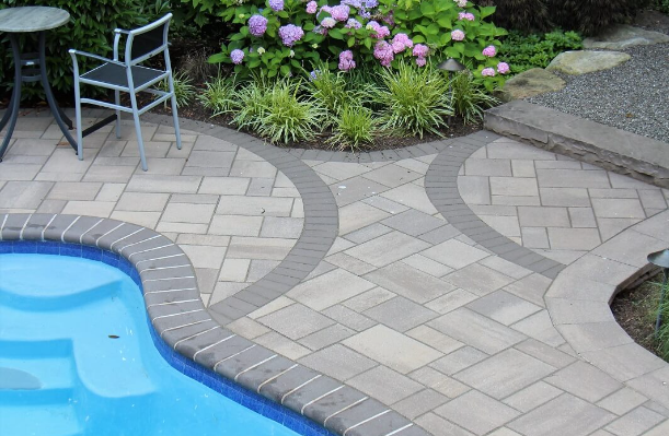 Patterned pavers in a pool surround - 2024 landscape design trends -Burkholder Landscape