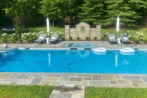 pool with built in spa, flagstone surround and seating | New landscape project | Burkholder Landscape