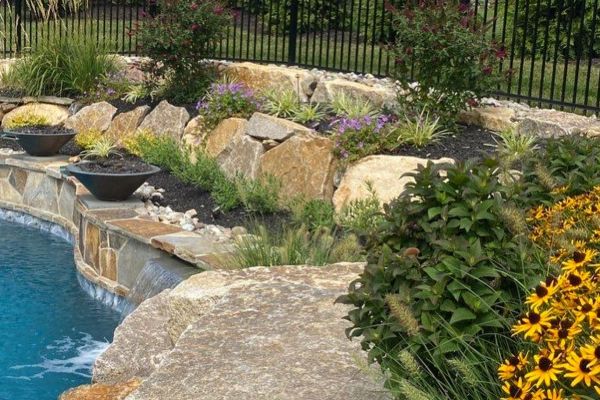 Retaining wall using Techo-Bloc 6&rdquo; Mini Creta Architectural caps in beautiful chestnut brown, and stone granite boulders - Pool and Patio Retreat - New Projects by Burkholder Landscape